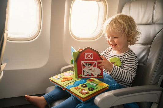 Kid playing Habi Kids Quiet Book on plane
